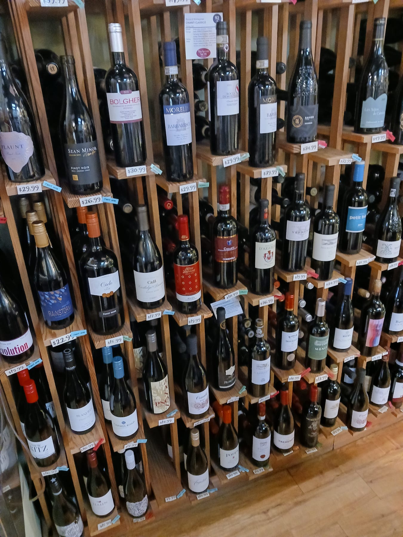 Curated wine bottles on angled wooden racks